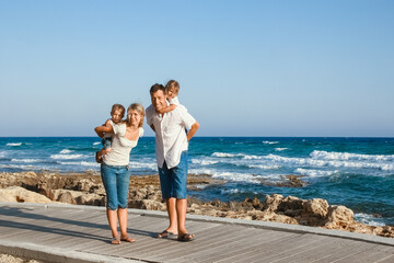 A happy family playing by the sea in nature travel