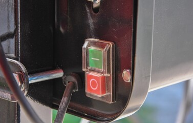 green start button and red stop button. start and stop buttons on the panel of a construction...