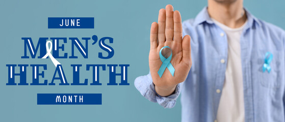 Young man with blue ribbon on color background, closeup. Prostate cancer awareness concept