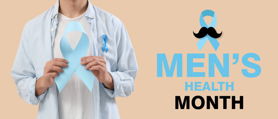Young man with blue ribbons on beige background, closeup. Prostate cancer awareness concept