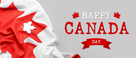 Flag of Canada and paper maple leaf on grey background