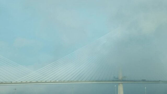 Static clip of traffic on the bridge and moving clouds. The Queensferry Crossing, Scotland, United Kingdom