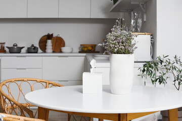 Dining table with dried lavender in interior of modern kitchen