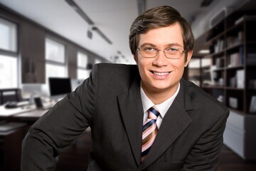 Naklejka premium Portrait of successful businessman in suit working inside office building