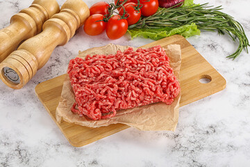 Raw minced beef meat on cutting board