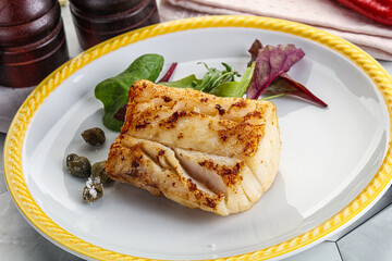 Roasted cod fish steak with salad