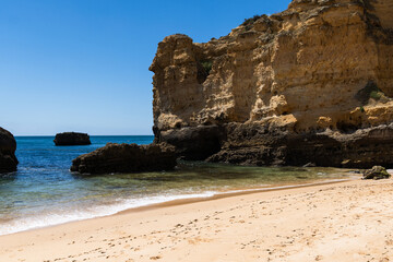 São Rafael beach, Albufeira, Algarve, Portugal. Sunny day. Rocks and cliffs on the beach. Crystal clear sea