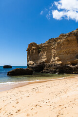 São Rafael beach, Albufeira, Algarve, Portugal. Sunny day. Rocks and cliffs on the beach. Crystal clear sea