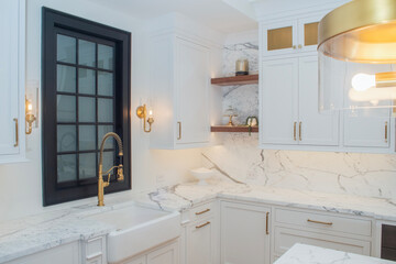 High end custom kitchen with white cabintes and granite counter top