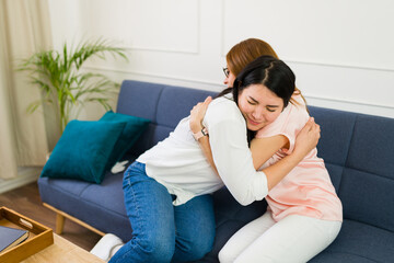 Therapist hugging and comforting a crying woman during a therapy session