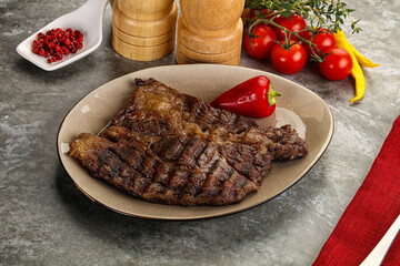 Grilled chuck roll steak with arugula