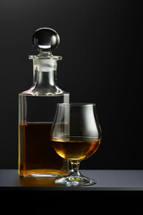 Old decanter and glass with whiskey, cognac or brandy.
