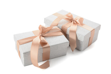 Gift boxes tied with beige ribbon on white background
