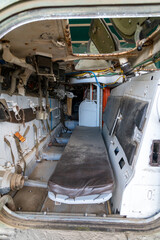 Old abandoned rusty military truck interior.