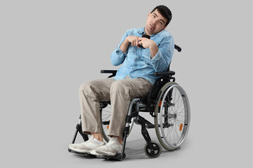 Young man in wheelchair on light background. National Cerebral Palsy Awareness Month