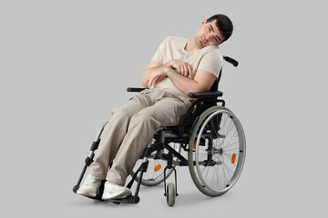 Young man in wheelchair on light background. National Cerebral Palsy Awareness Month