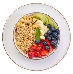 Granola with strawberries, kiwi, banana and blueberries in a white round plate