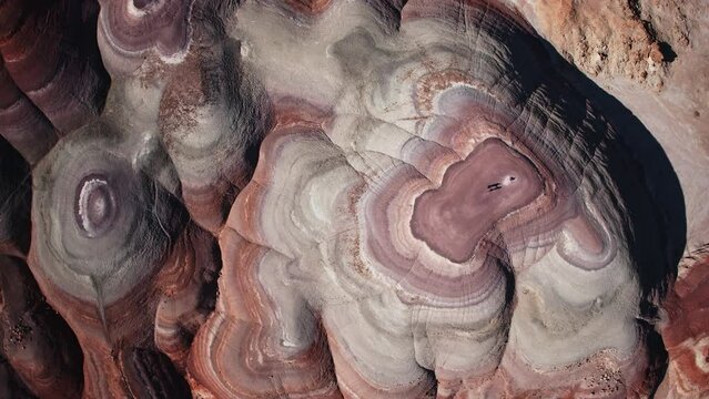 Aerial flyover view directly above colorful Bentonite Hills / Caineville, Utah, United States