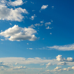 White fluffy clouds on blue sky.