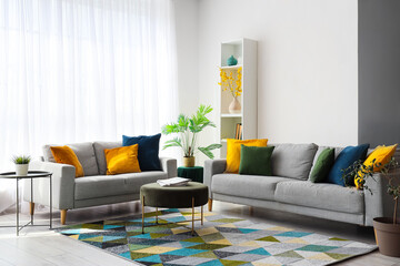 Interior of stylish living room with colorful pillows on sofas