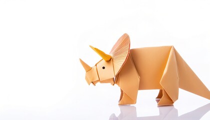 Animal extinct reptile or bird concept origami isolated on white background of a triceratops dinosaur, with copy space, simple starter craft for kids
