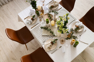 Beautiful table setting with eustoma flowers and eucalyptus for wedding celebration in room, top view