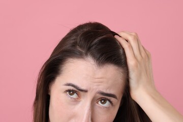 Sad woman with hair loss problem on pink background, closeup