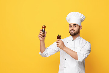 Professional chef with shakers on yellow background. Space for text