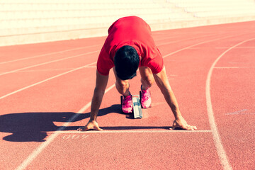 Stadium, man running and start block of athlete on a runner and arena track for sprint