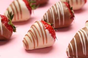 Delicious chocolate covered strawberries on pink background, closeup