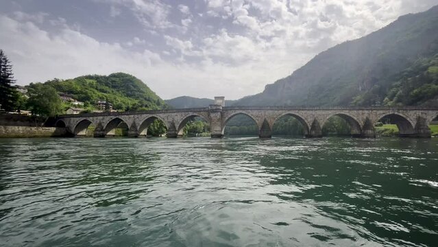 Riverboat view of Mehmed Pasa Sokolovic Bridge over the Drina River in Republika Srpska. This UNESCO-listed Ottoman stone bridge, built in the 16th century, showcases stunning architecture and history