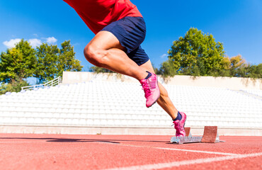 Stadium, man running and start block of athlete on a runner and arena track for sprint