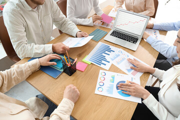 Business people with diagrams working on marketing plan in office, closeup