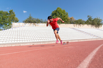 Stadium, man running and start block of athlete on a runner and arena track for sprint
