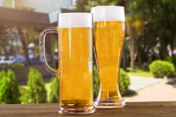 Beer two glasses with white Foam on the desk