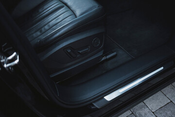 Modern black subcompact electric crossover SUV with black interior. Details interior.
