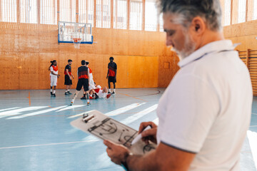 Basketball players training in a sports hall