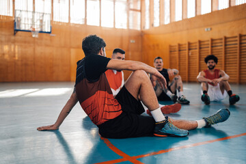 Basketball player warming up before training in a sports hall
