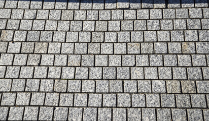 Abstract background. Old cobblestone pavement close-up. Square Texture Pattern. granite pavement