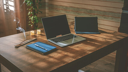 Home Office. Organization of the workplace. On the table there is a laptop, a tablet and a blue...