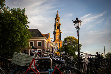 The historic Westerkerk in Amsterdam, Netherlands with bikes in the foreground