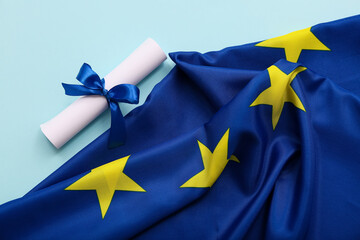 Diploma with blue ribbon and European Union flag on light blue background