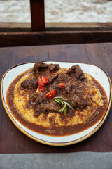 Dish of polenta and meat.