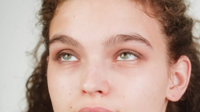 Eye shadow makeup to the upper eyelid, close-up. Makeup artist applies a bright eye shadow with a make-up brush.Tutorial master class of professional makeup, smoky eyes 
