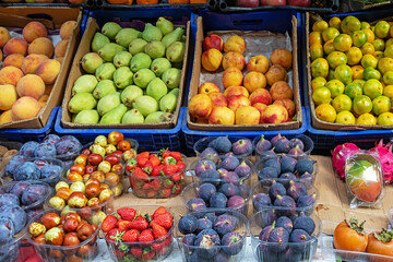 Fresh organic raw ripe fruits sold outside on a market stall