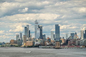 New York, NY, USA - August 1, 2023: 30 Hudson Yards and other skyskrapers under blue cloudscape. I want to thank you message on Pier 40. Small brown tower Holland Tunnel ventilation shaft 2.