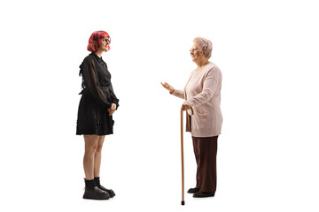 Elderly woman talking to a young woman in a black dress