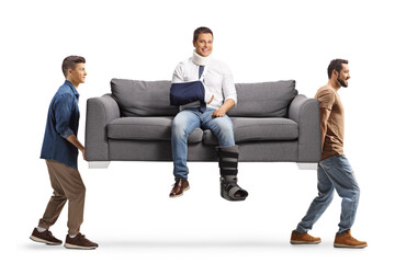 Injured man sitting on a sofa and two guys carrying the sofa
