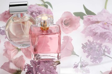 Two luxury perfumes on spring floral decor