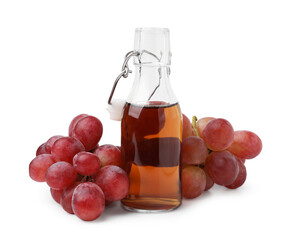Bottle with wine vinegar and grapes isolated on white